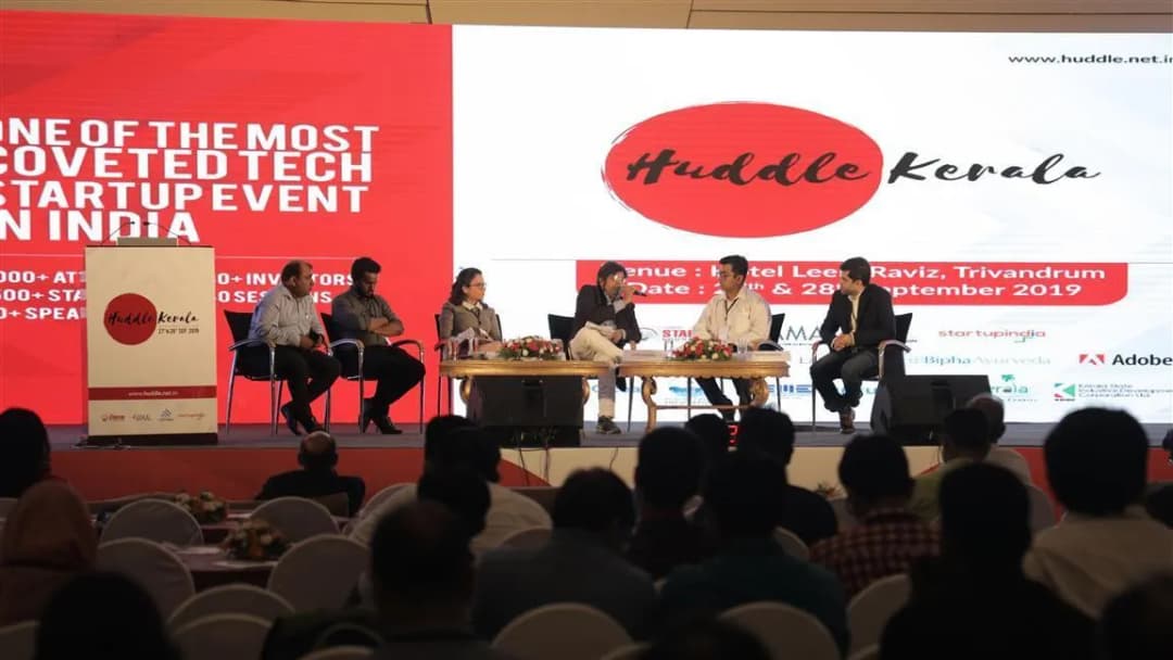 Panel discussion on stage during a corporate tech event
