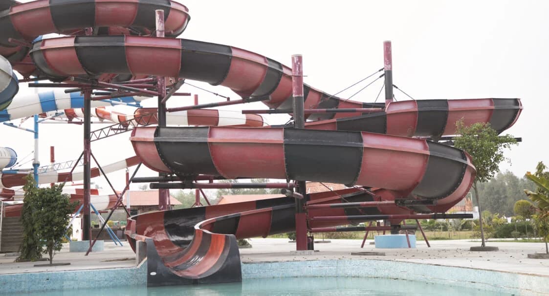 Flow Rider 1 - A turning open tube float slide where in riders slide down with high thrill of sway on turns.